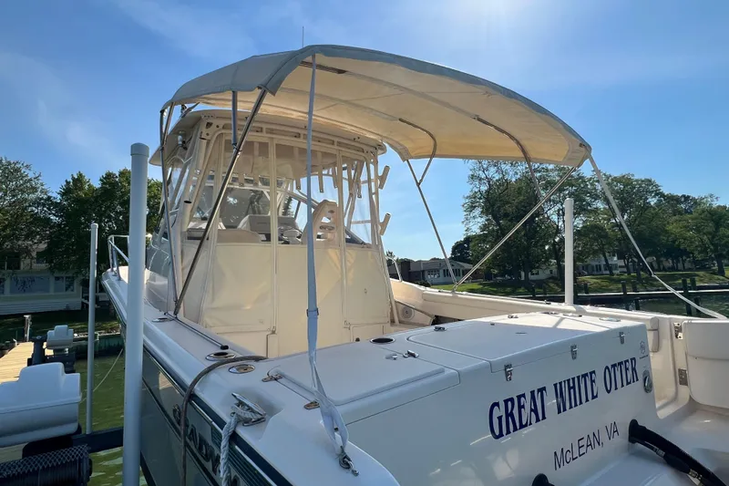 Slide: The Image of 2017 Grady-White Marlin 300 boat docked, featuring canopy and "Great White Otter" name. - 4