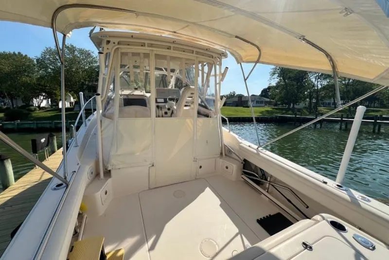 Slide: The Image of 2017 Grady-White Marlin 300 boat docked, featuring spacious deck and canopy. - 5