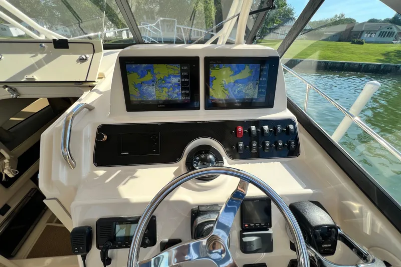 Slide: The Image of 2017 Grady-White Marlin 300 helm with dual navigation screens and controls. - 7
