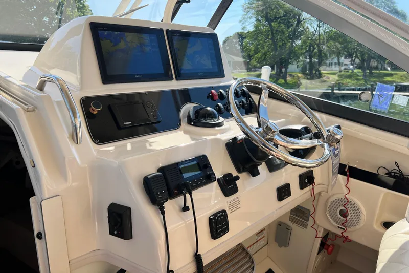 Slide: The Image of 2017 Grady-White Marlin 300 helm with dual displays and modern controls. - 8