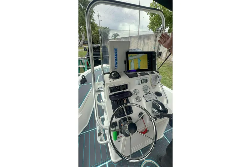 Slide: The Image of Control panel of a 2015 Mako 19 CPX boat with navigation equipment. - 13