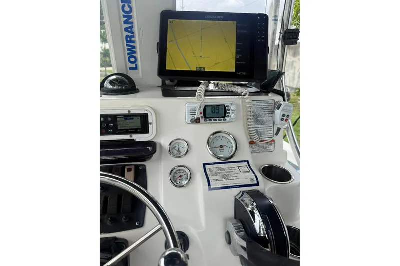 Slide: The Image of Control panel of a 2015 Mako 19 CPX boat with navigation equipment. - 14
