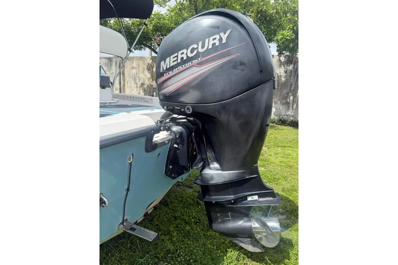 Slide: The Image of 2015 Mako 19 CPX boat with Mercury FourStroke outboard motor on grass. - 8