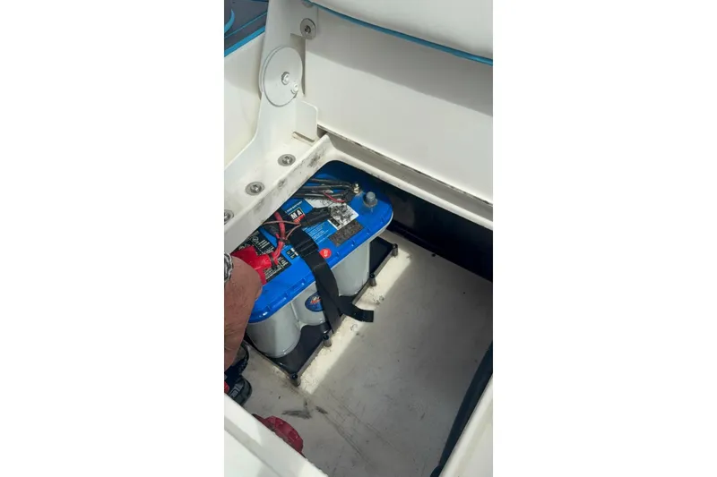 Slide: The Image of Battery compartment of a 2015 Mako 19 CPX boat with secured marine battery. - 9