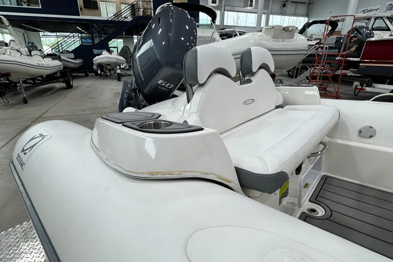 Slide: The Image of 2021 Zodiac Yachtline 440 inflatable boat interior with seating and motor in showroom. - 10