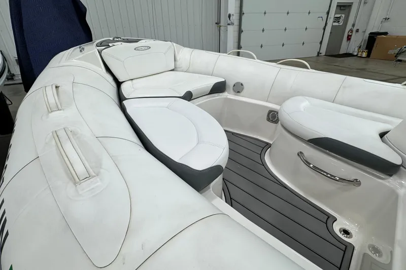 Slide: The Image of 2021 Zodiac Yachtline 440 interior with white seating and sleek design in a garage setting. - 5