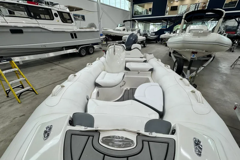 Slide: The Image of 2021 Zodiac Yachtline 440 inflatable boat in showroom, featuring sleek white design and modern seating. - 8
