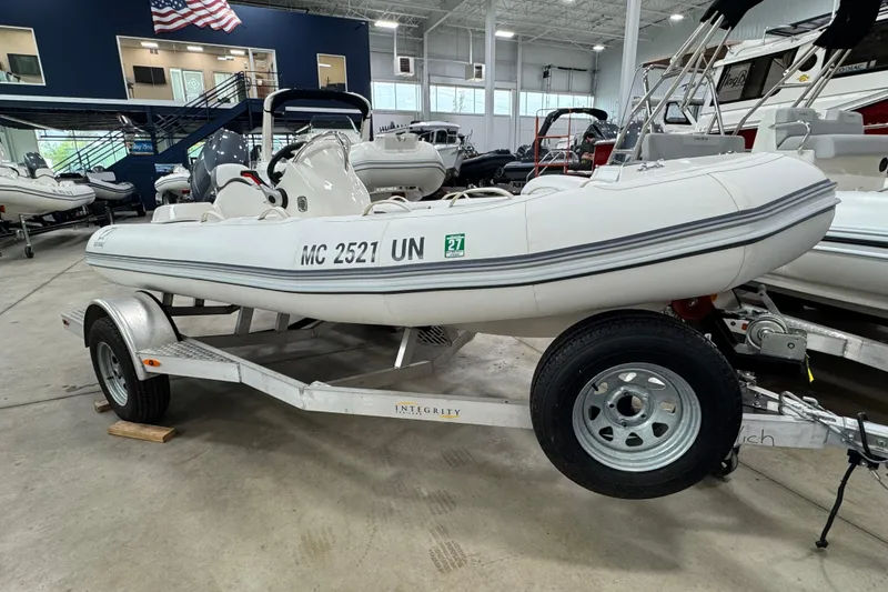 Slide: The Image of 2021 Zodiac Yachtline 440 inflatable boat on trailer in showroom. - 9