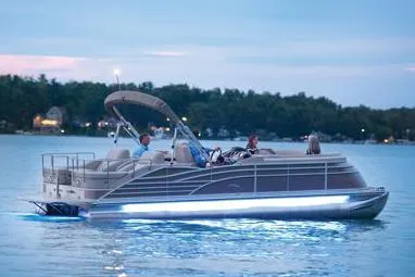 Slide: The Image of Manufacturer Provided Image: 2015 Bennington 2575 QSD pontoon boat on a serene lake at dusk. - 1