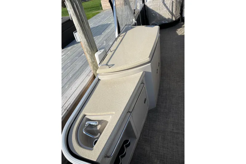 Slide: The Image of 2015 Bennington 2575 QSD boat interior with sleek countertop and built-in sink. - 15