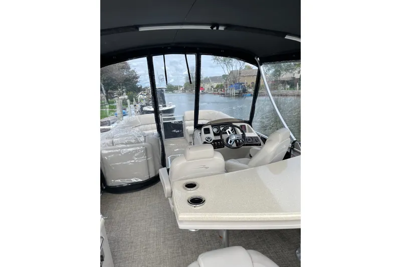 Slide: The Image of Interior view of 2015 Bennington 2575 QSD boat with steering console and seating. - 19