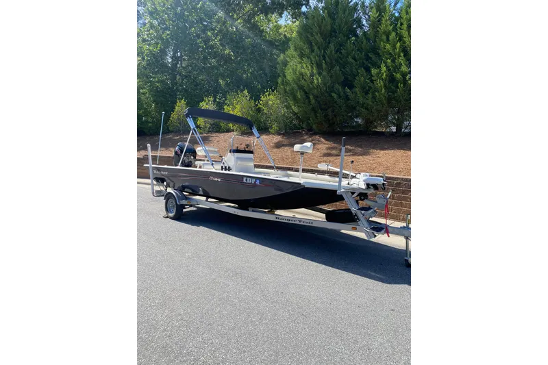 Slide: The Image of 2020 RAB RB190 boat on trailer, parked on a sunny street. - 2