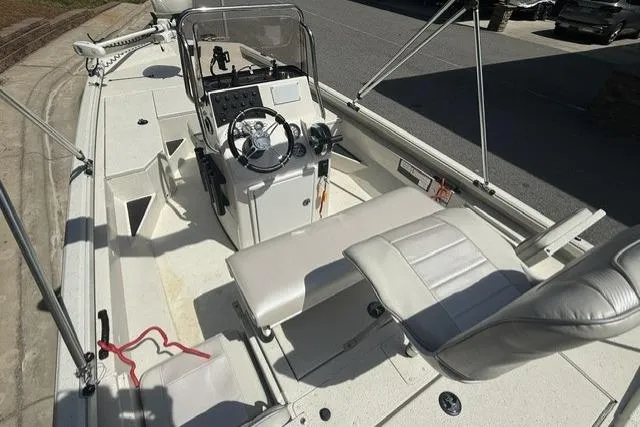 Slide: The Image of 2020 RAB RB190 boat interior with steering console and seating, parked on a sunny day. - 5
