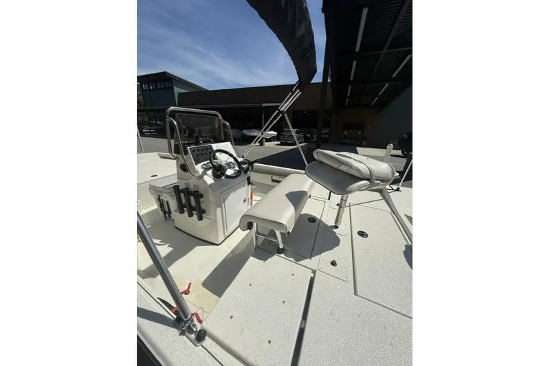 Slide: The Image of 2020 RAB RB190 boat interior with steering console and seating under a canopy. - 8