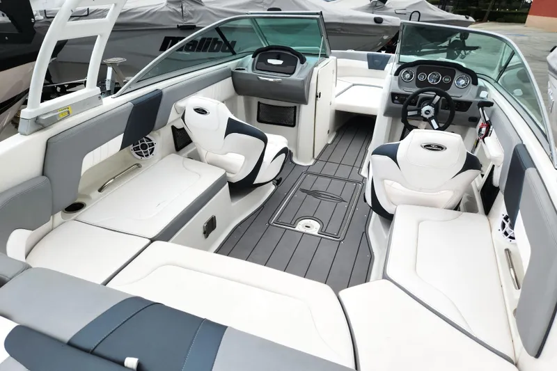 Slide: The Image of 2021 Chaparral 23 SSi boat interior with modern seating and dashboard design. - 4