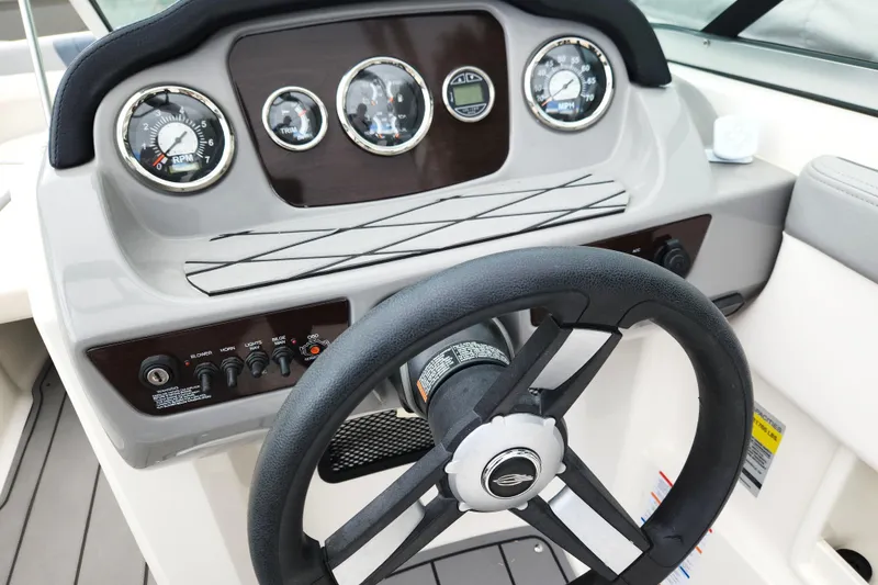 Slide: The Image of 2021 Chaparral 23 SSi boat dashboard with steering wheel and gauges. - 6