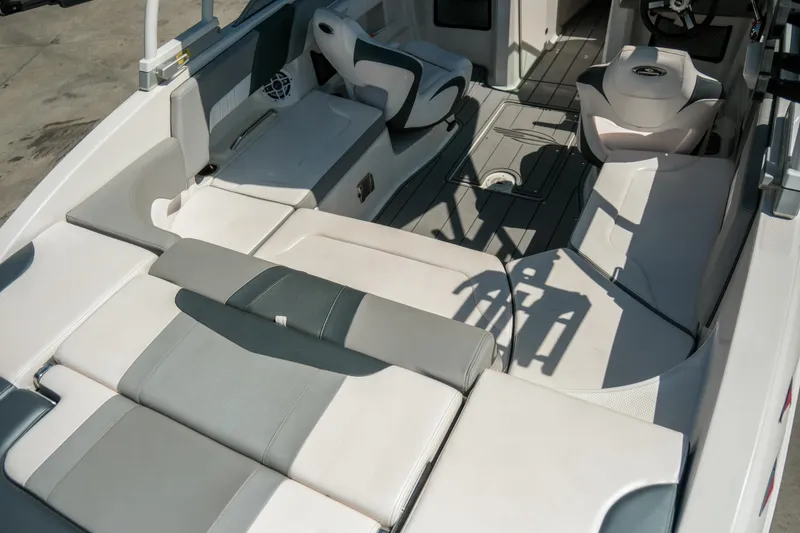 Slide: The Image of 2021 Chaparral 23 SSi boat interior with gray and white seating and modern design. - 9