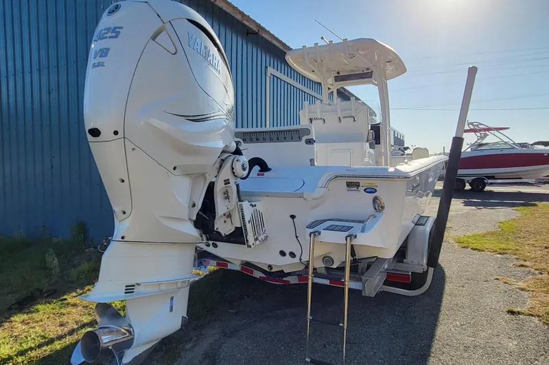 Slide: The Image of 2020 Tidewater 2700 Carolina Bay boat with Yamaha 425 V8 engine, docked outdoors. - 2