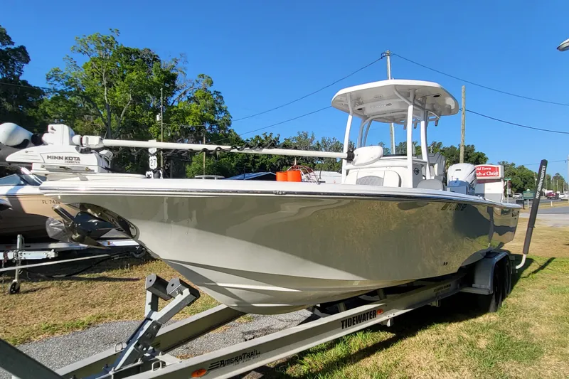 Slide: The Image of 2020 Tidewater 2700 Carolina Bay boat on trailer, parked outdoors under clear blue sky. - 3