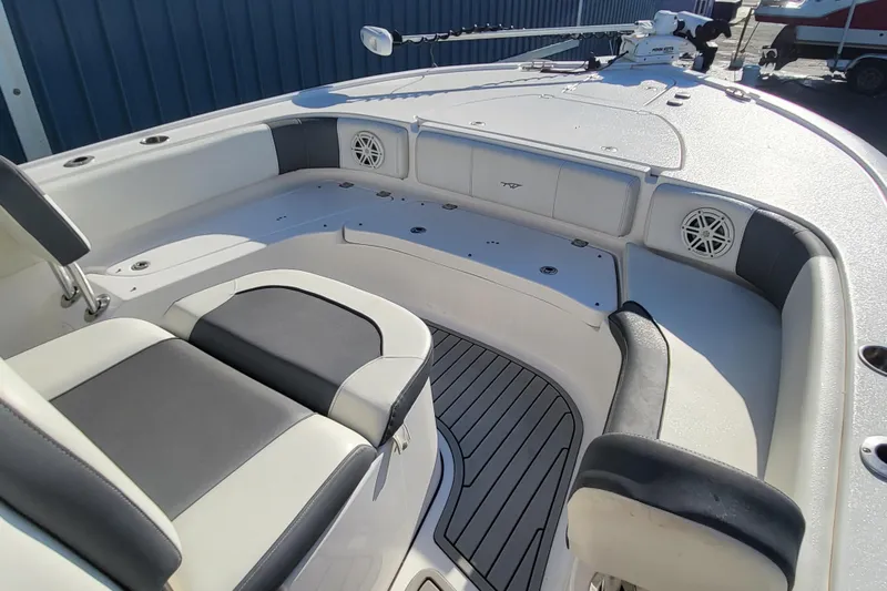 Slide: The Image of 2020 Tidewater 2700 Carolina Bay boat interior with cushioned seating and speakers. - 6