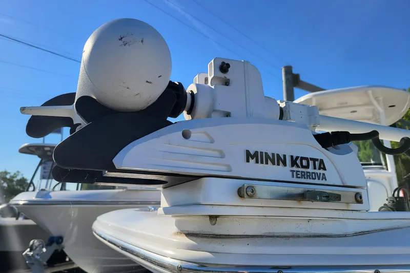 Slide: The Image of Minn Kota Terrova motor on 2020 Tidewater 2700 Carolina Bay boat under clear blue sky. - 9