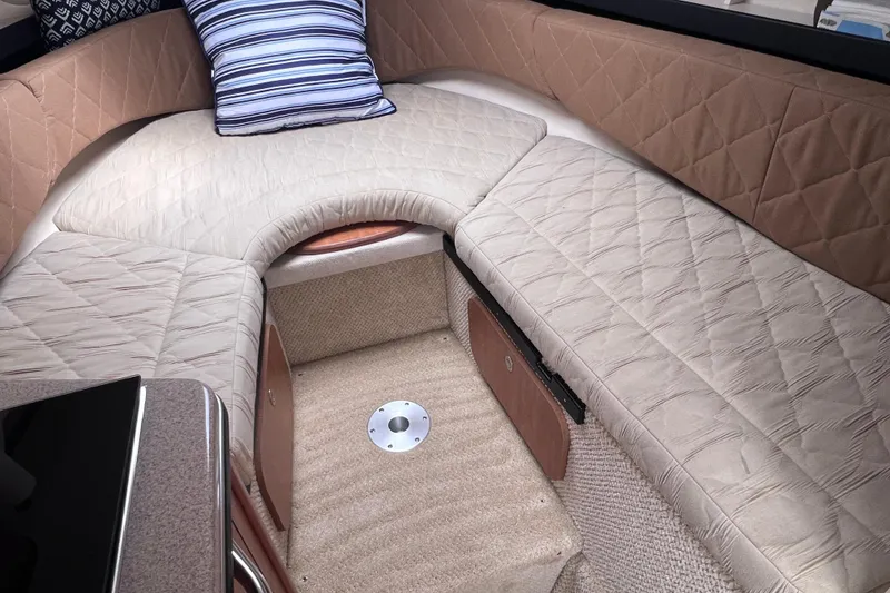 Slide: The Image of Interior cabin of 2006 Sea Ray Sundancer 260 with beige seating and striped pillow. - 15