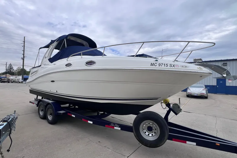 Slide: The Image of 2006 Sea Ray Sundancer 260 boat on trailer, parked outdoors. - 4