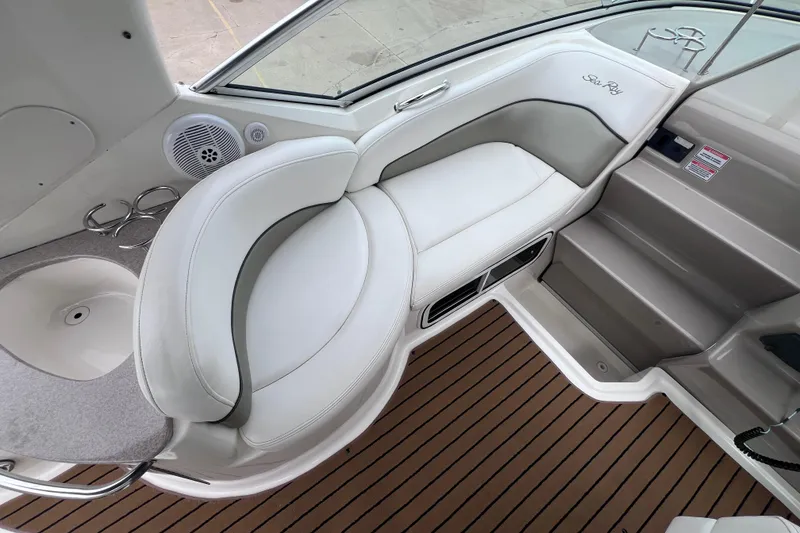 Slide: The Image of 2006 Sea Ray Sundancer 260 interior with white seating and wood-style flooring. - 8