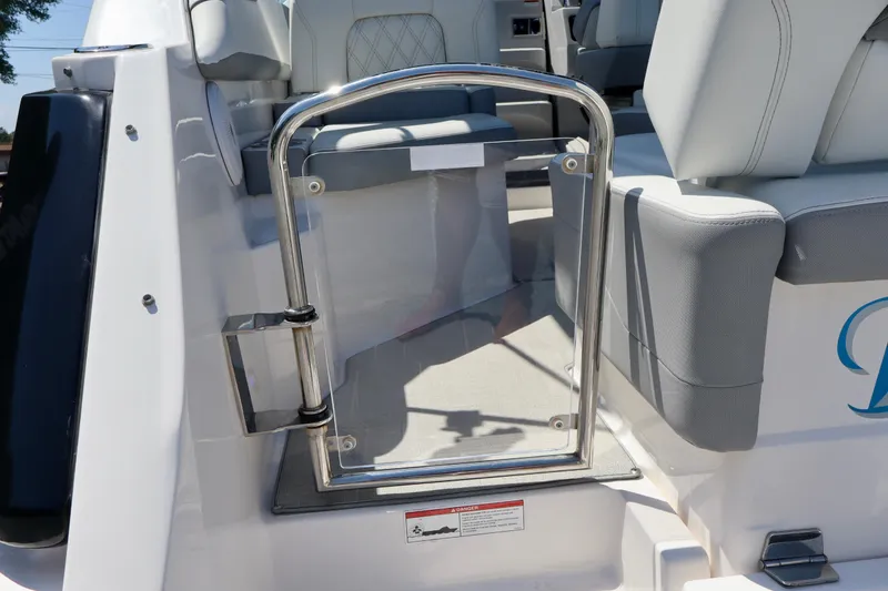 Slide: The Image of 2023 Regal 26 XO boat interior with sleek seating and stainless steel gate. - 12