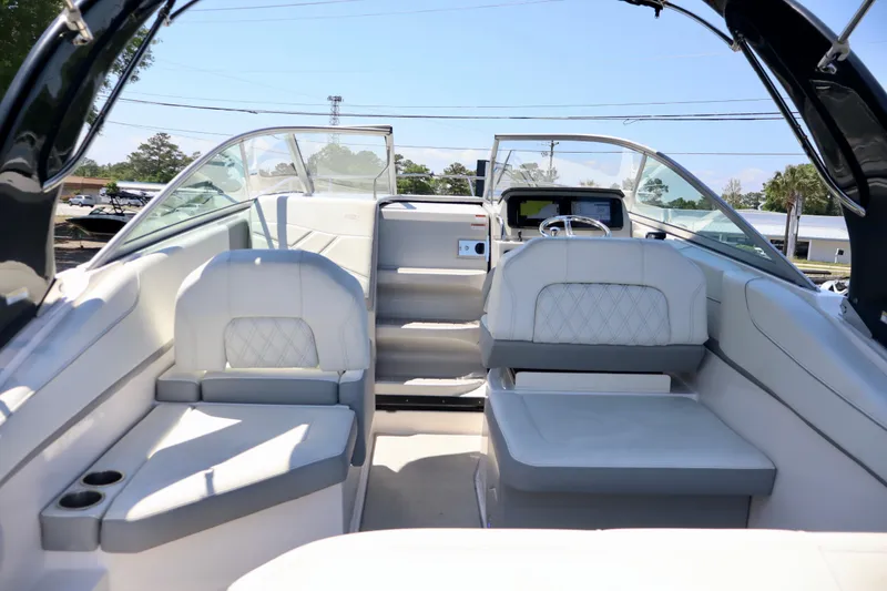 Slide: The Image of 2023 Regal 26 XO boat interior with luxurious seating and modern dashboard. - 13