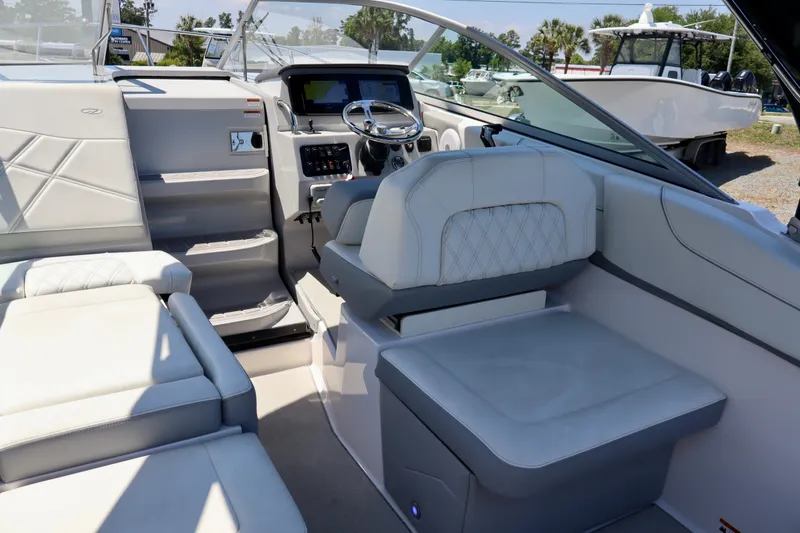 Slide: The Image of 2023 Regal 26 XO boat interior with luxurious seating and modern dashboard. - 14