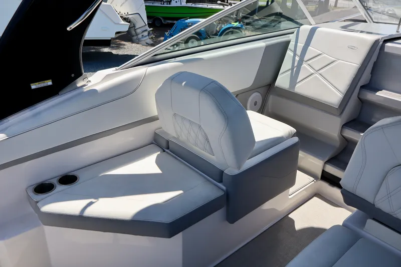 Slide: The Image of 2023 Regal 26 XO boat interior with white seating and cup holders. - 16