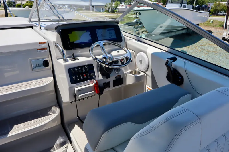 Slide: The Image of 2023 Regal 26 XO boat cockpit with modern steering and navigation system. - 17