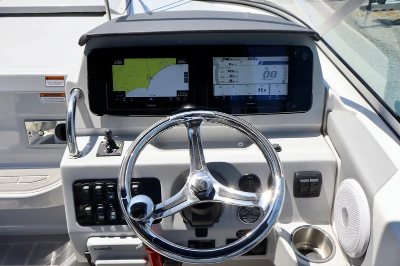 Slide: The Image of Helm of 2023 Regal 26 XO boat with Garmin navigation display and controls. - 18
