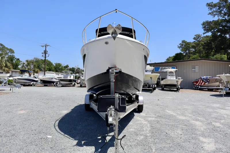 Slide: The Image of 2023 Regal 26 XO boat on trailer in outdoor dealership lot. - 2