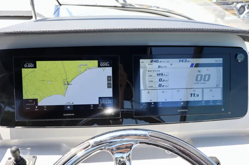 Slide: The Image of Garmin navigation displays on 2023 Regal 26 XO boat dashboard, showing maps and boat status. - 20
