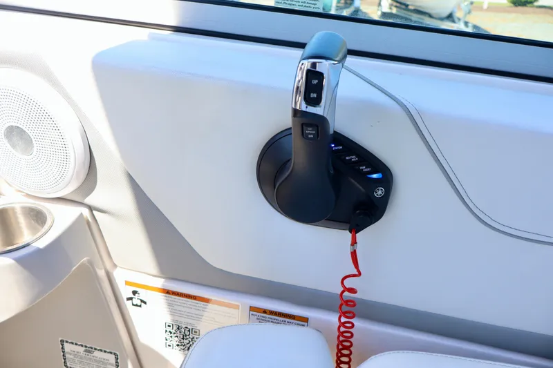 Slide: The Image of 2023 Regal 26 XO boat throttle control with speaker and safety features. - 22