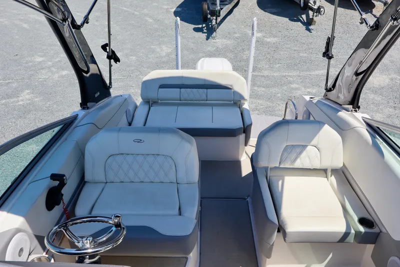 Slide: The Image of 2023 Regal 26 XO boat interior with luxurious seating and modern steering wheel. - 23