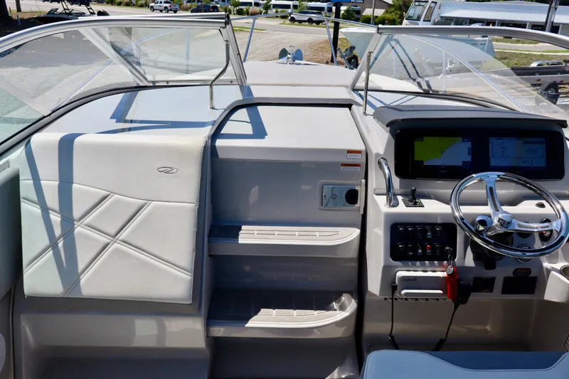 Slide: The Image of 2023 Regal 26 XO boat cockpit with modern steering and navigation system. - 24