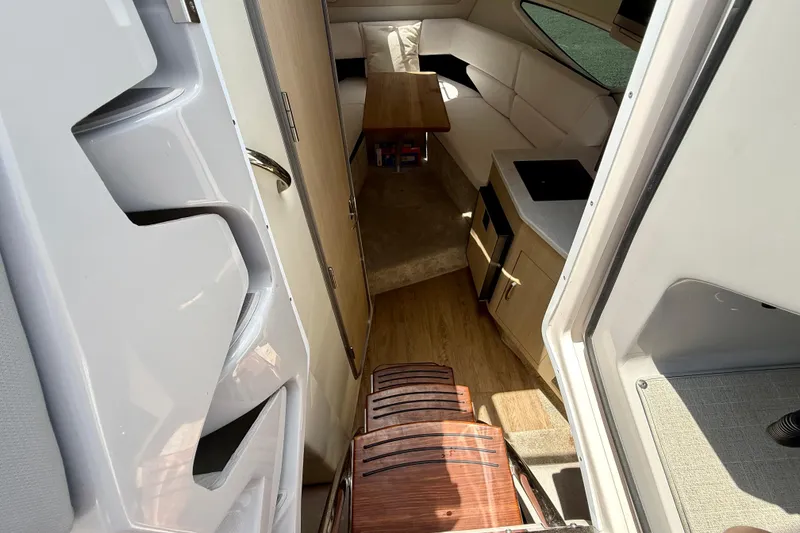 Slide: The Image of Interior of 2023 Regal 26 XO boat, featuring modern seating and compact kitchenette. - 27