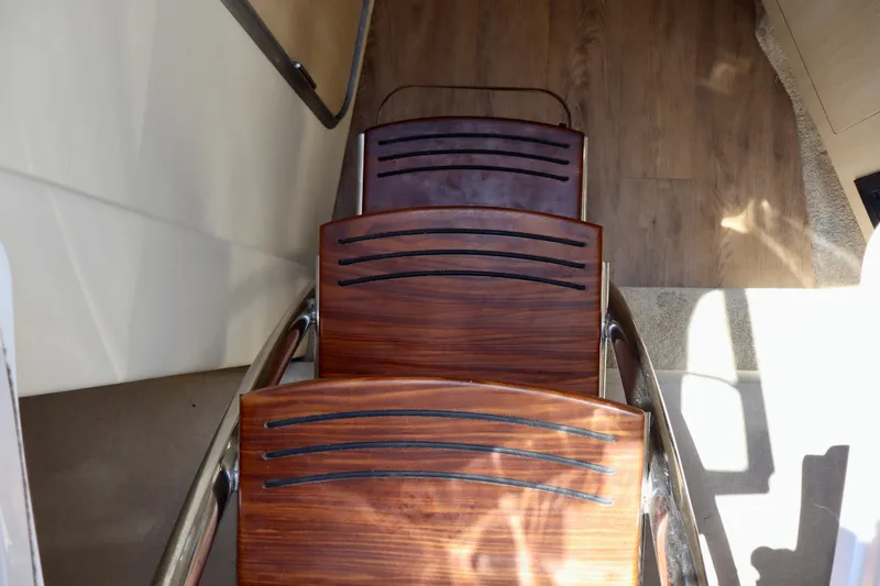 Slide: The Image of Wooden steps on a 2023 Regal 26 XO boat interior. - 28