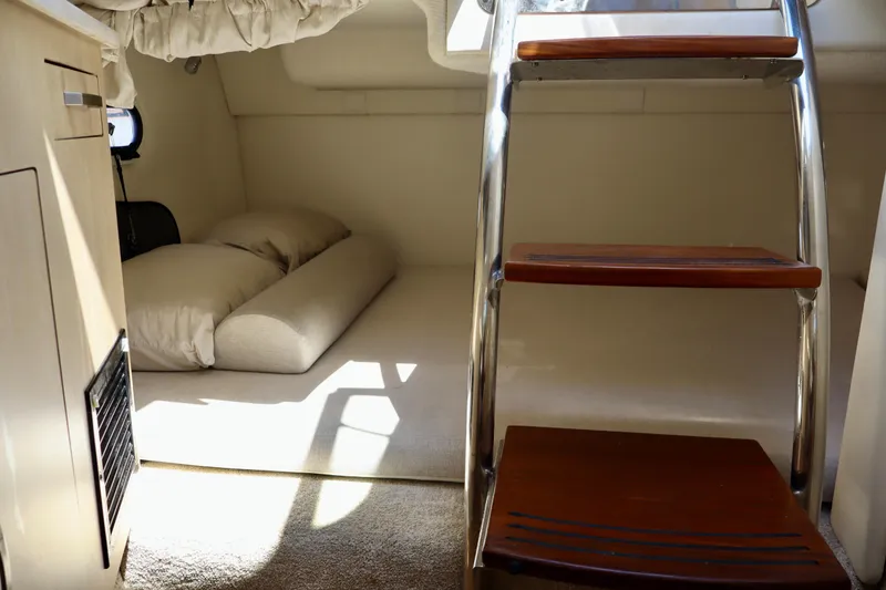 Slide: The Image of Interior cabin of 2023 Regal 26 XO boat with cozy sleeping area and wooden steps. - 36