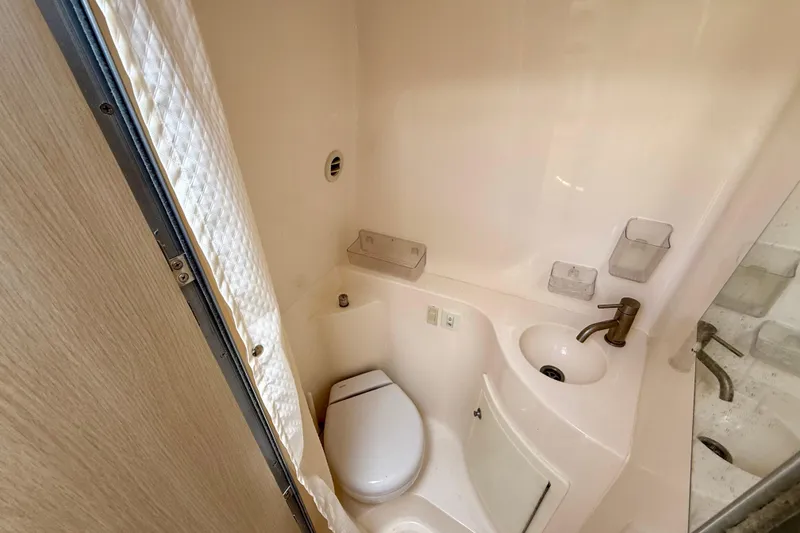 Slide: The Image of Compact bathroom in 2023 Regal 26 XO boat with toilet and sink. - 38