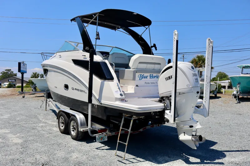 Slide: The Image of 2023 Regal 26 XO boat with Yamaha engine on trailer, outdoor display. - 6