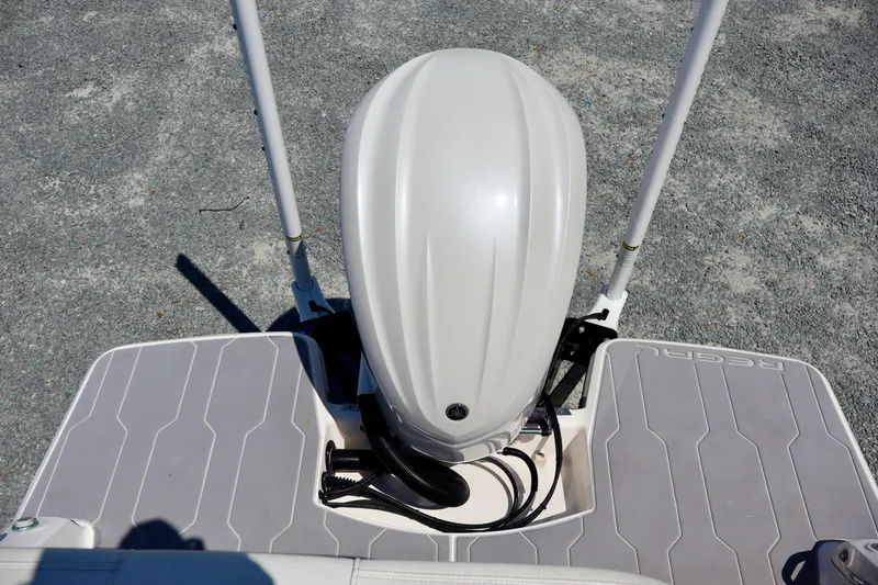 Slide: The Image of 2023 Regal 26 XO boat with outboard motor, viewed from above on a textured surface. - 9