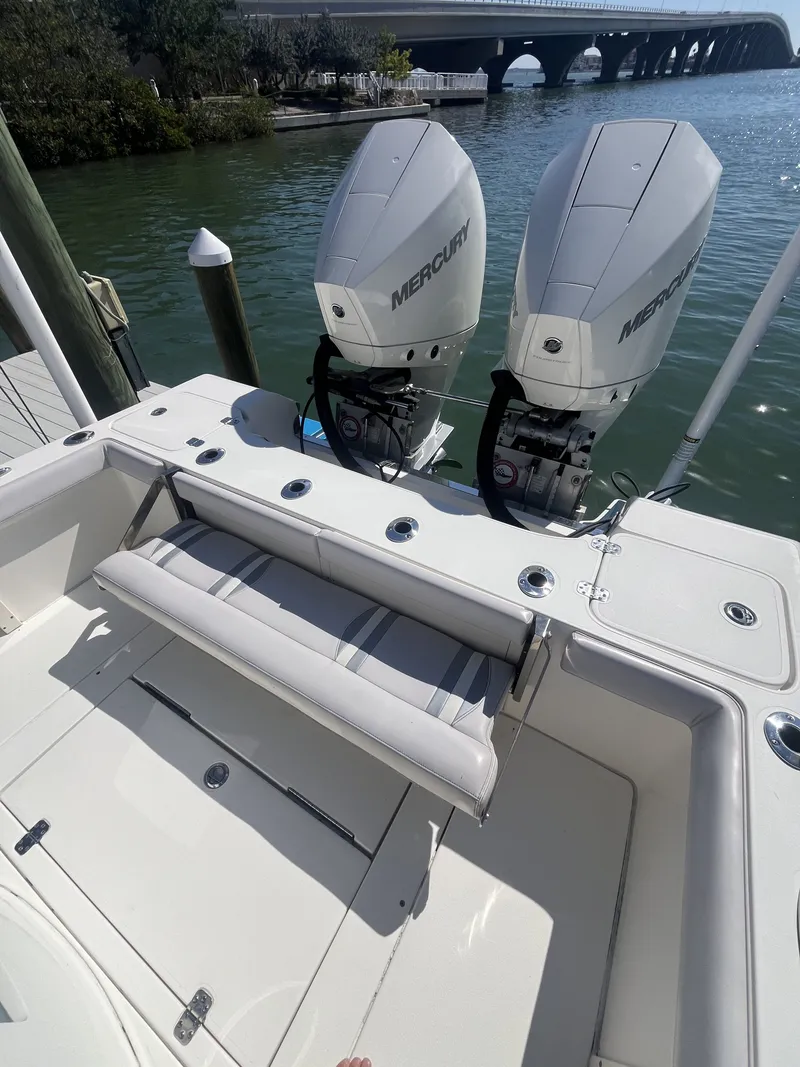 Slide: The Image of ShearWater Carolina 2020 boat with twin Mercury engines by the water. - 13