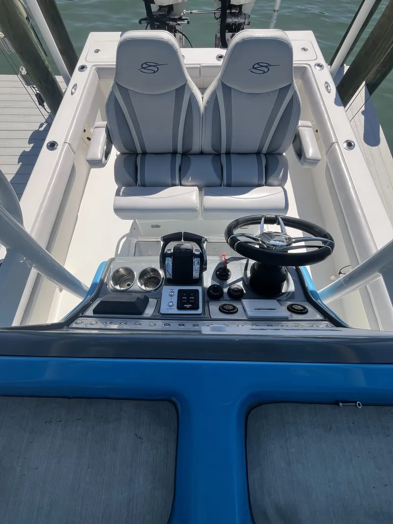 Slide: The Image of Interior view of a 2020 ShearWater Carolina boat with steering console. - 15