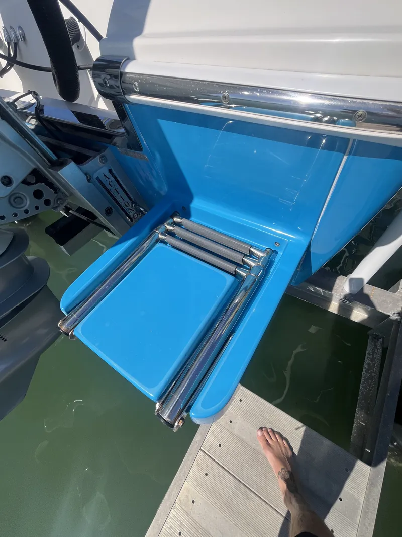 Slide: The Image of ShearWater Carolina 2020 boat with blue swim ladder at dock. - 18