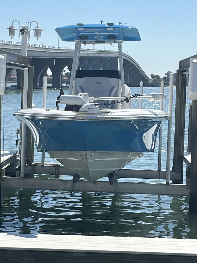 Slide: The Image of 2020 ShearWater Carolina boat on a lift near a bridge. - 2