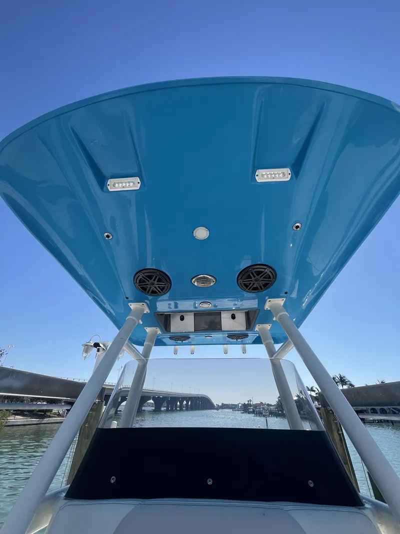 Slide: The Image of ShearWater Carolina 2020 boat with blue canopy and speakers. - 22